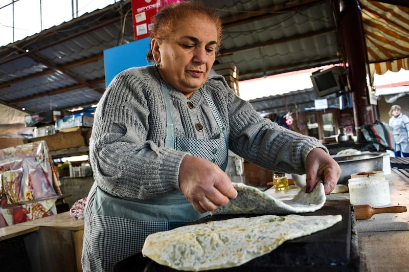 A vendor sells a traditional bread at a street market in Karabakh's main city of Stepanakert on November 28, 2020. AFP