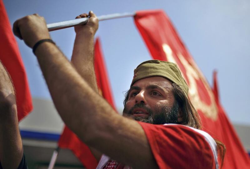 A member of the Lebanese Communist party, waves the party’s flag, during a demonstration to mark International Labor Day or May Day, in Beirut, Lebanon. Bilal Hussein / AP Photo