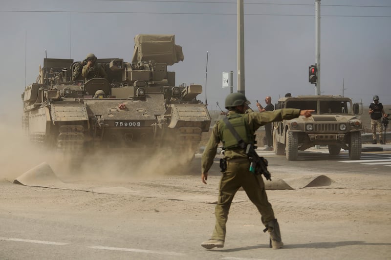 A soldier gives directions to a tank unit near the border with Gaza on Saturday near Sderot, Israel. Getty