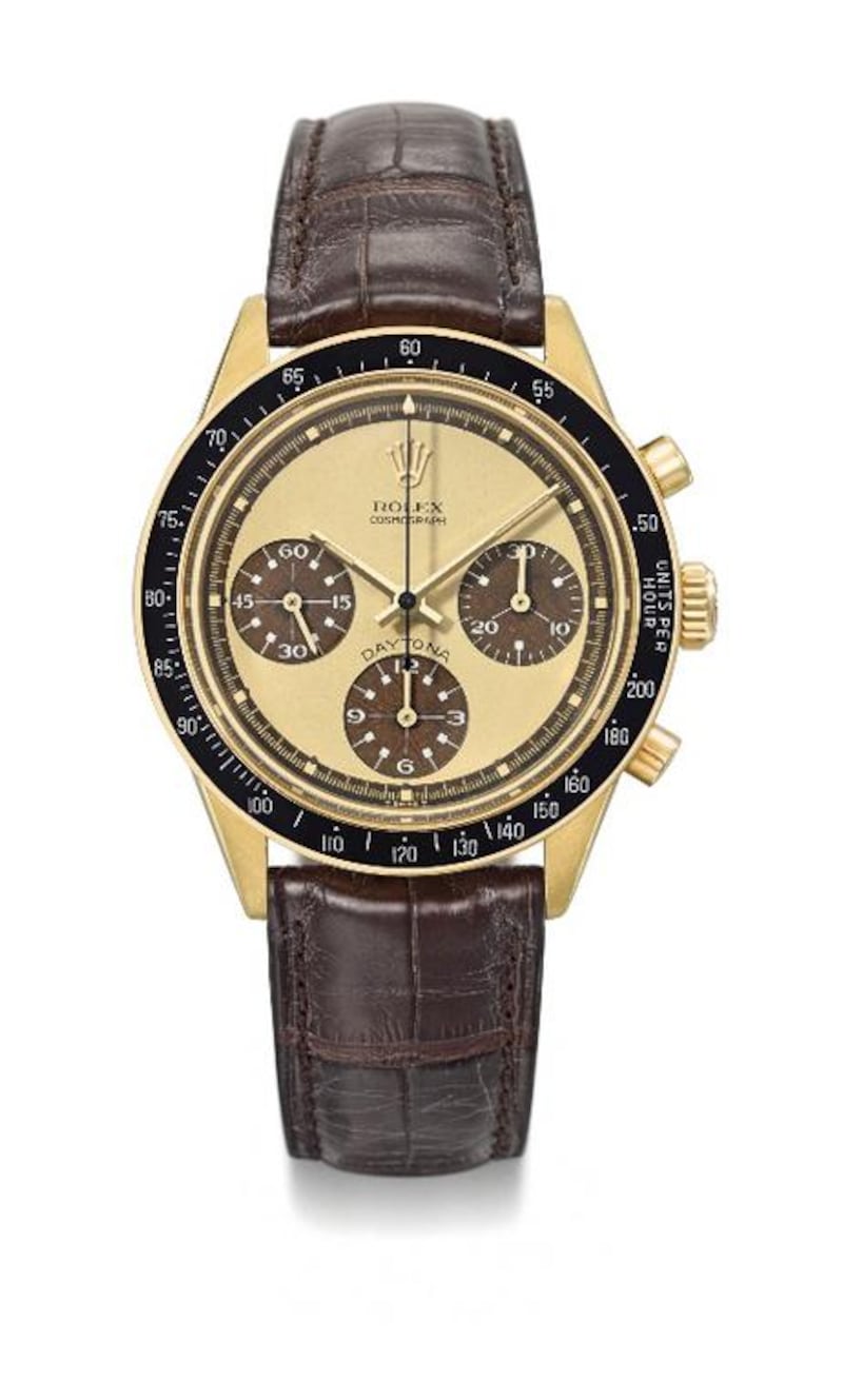 The 18K gold chronograph wristwatch with tropical lemon dial and white numerals, Rolex Daytona, Paul Newman model, reference 6264, from circa 1970. Courtesy Christie’s