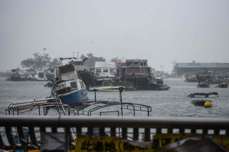 A boat lists in a typhoon shelter in the village of Lei Yu Mun. AFP