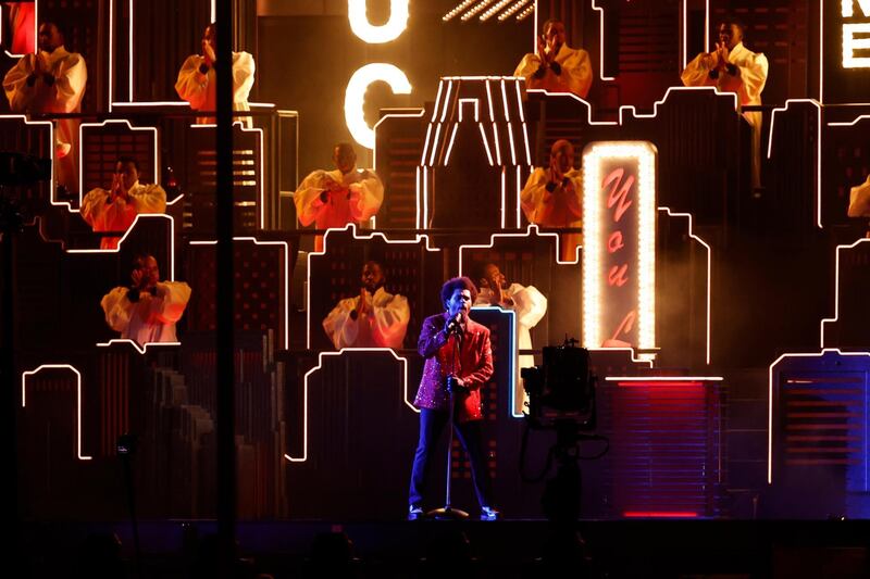 The Weeknd performs in his signature red blazer. EPA