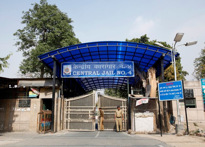 Police stand guard at one of the gates of the Tihar Jail in New Delhi March 11, 2013. The driver of the bus in which a young Indian woman was gang-raped and fatally injured in December hanged himself in his jail cell on Monday, prison authorities said, but his family and lawyer said they suspected "foul play". Ram Singh, the main accused in India's most high-profile criminal case, killed himself in a cell he shared with three other inmates in New Delhi's Tihar jail just before dawn, prison spokesman Sunil Gupta said. REUTERS/Mansi Thapliyal (INDIA - Tags: CRIME LAW MILITARY)