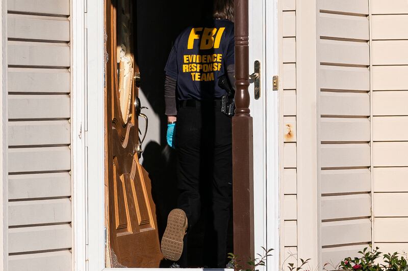 Members of the FBI search the home of suspected gunman Andre Bing. Getty Images / AFP 