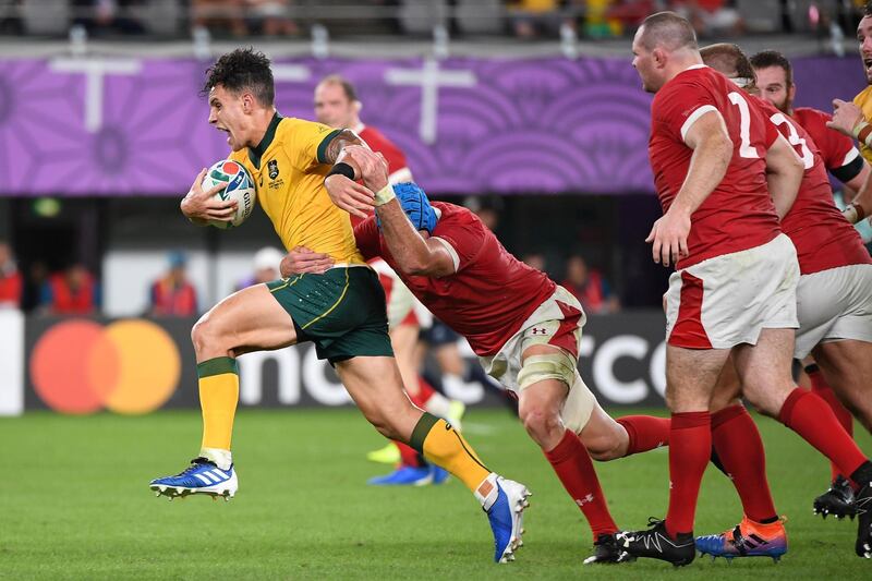 Australia's Matt To'omua is tackled by Wales flanker Justin Tipuric at the Tokyo Stadium. AFP