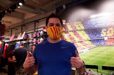 A man wearing a protective face mask poses during the presentation of official FC Barcelona brand masks. EPA
