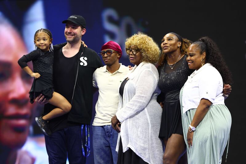 Serena Williams poses for a photo with family and friends following her victory against Danka Kovinic at the US Open.  Getty Images 

