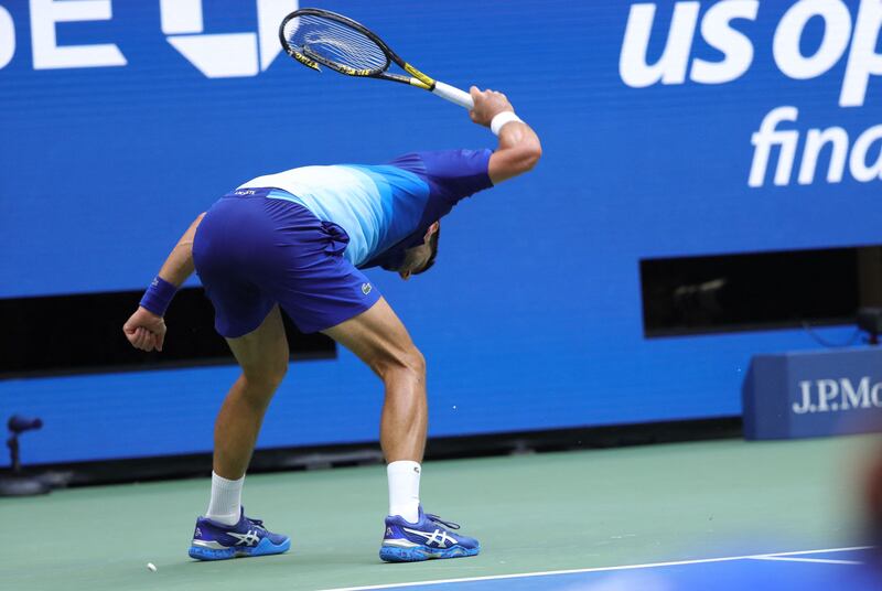 Novak Djokovic of Serbia smashes his racket in frustration. AFP