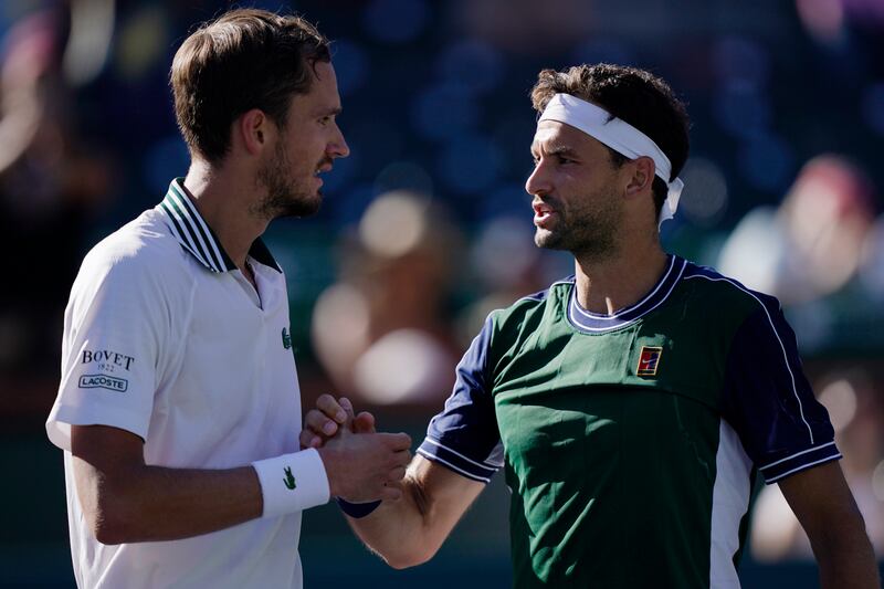 Grigor Dimitrov, right, shakes hands with Daniil Medvedev after their match at the BNP Paribas Open. AP Photo