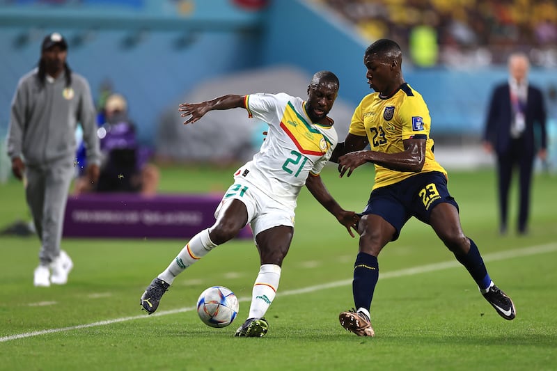 Senegal's Youssouf Sabaly tussles with Moises Caicedo of Ecuador. Getty 