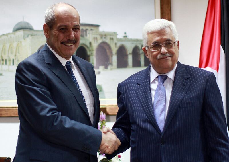 Palestinian President Mahmoud Abbas (R) shakes hands with Fayez Tarawneh as they met in Ramallah in October 2012. AFP