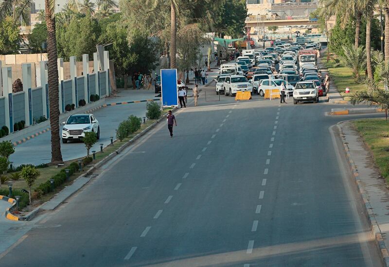 Security forces close a street during a curfew to help prevent the spread of the coronavirus, in Baghdad. AP Photo