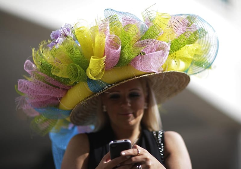 Ashley Cebak of Chicago looks at her phone before the 140th running of the Kentucky Derby horse race. David Goldman / AP photo