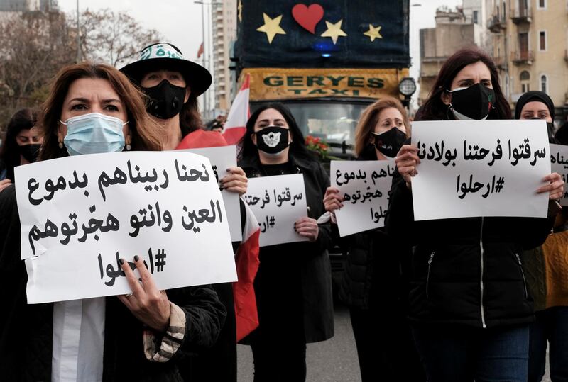 Mothers and activists carry signs as they take part in a march to protest against the political and economic situation, ahead of Mother's Day in Beirut. The signs read: "We've raised them with our tears, only for you to force them abroad" (L) and "You stole our right to enjoy our children"(R). Reuters