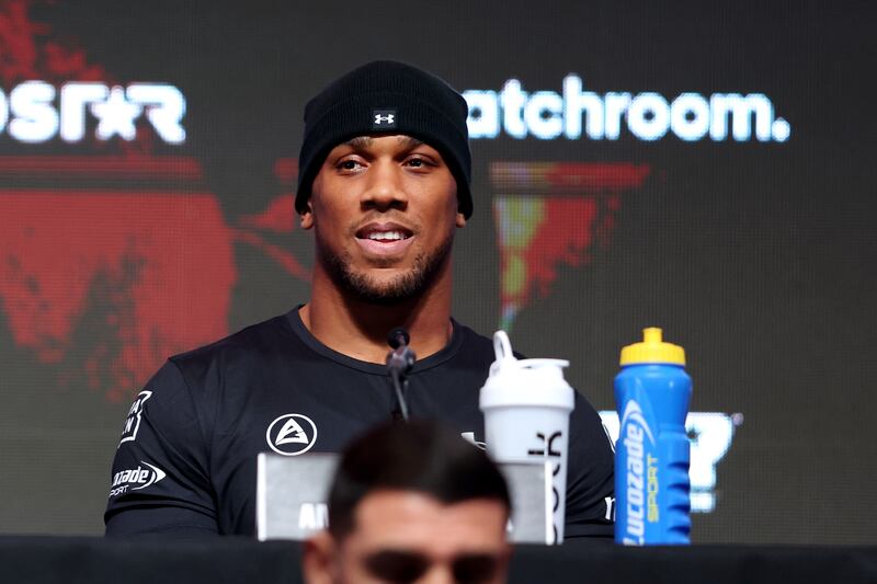 Anthony Joshua of Great Britain looks on from the top table. Getty Images