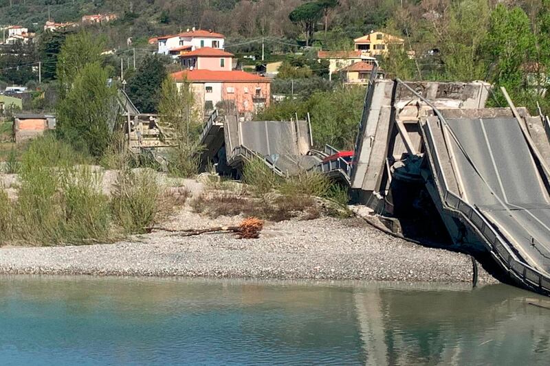 The debris of a bridge lies on a river bed after the bridge collapsed in Aulla, between the regions of Tuscany and Liguria, northern Italy, AP