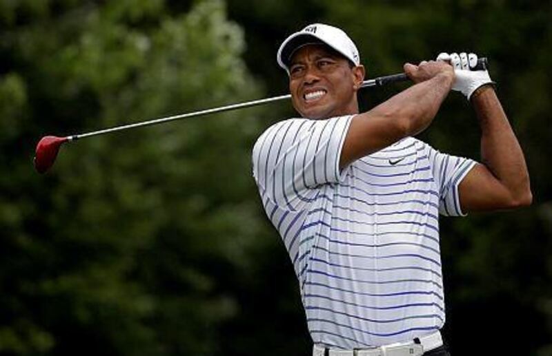 Tiger Woods winces after tee shot on the sixth hole during the second round of the PGA Championship golf tournament at Valhalla Golf Club in Louisville, Ky. Woods removed himself from consideration for the Ryder Cup team Wednesday evening, Aug. 13, 2014 with a clear message that he is not healthy enough to play. (AP Photo/Jeff Roberson, File)