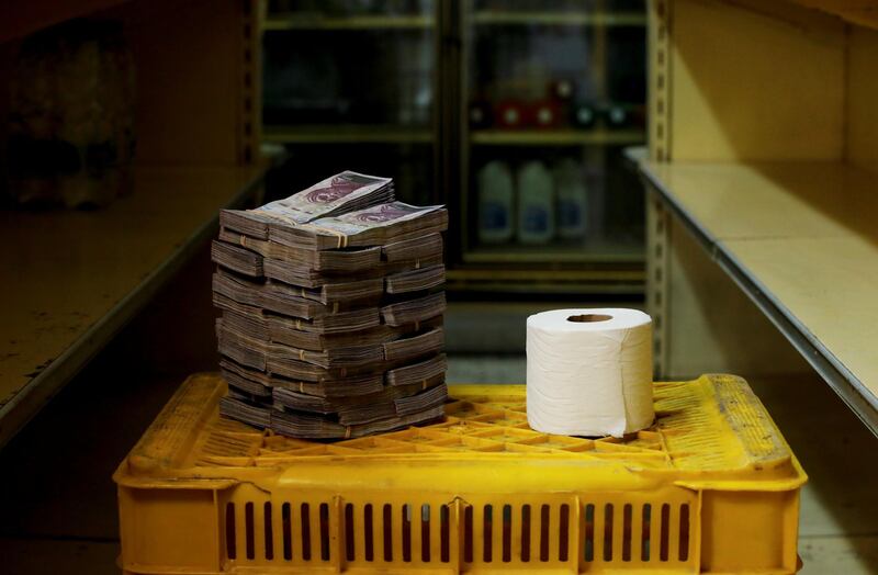 A roll of toilet paper is pictured next to 2,600,000 bolivars