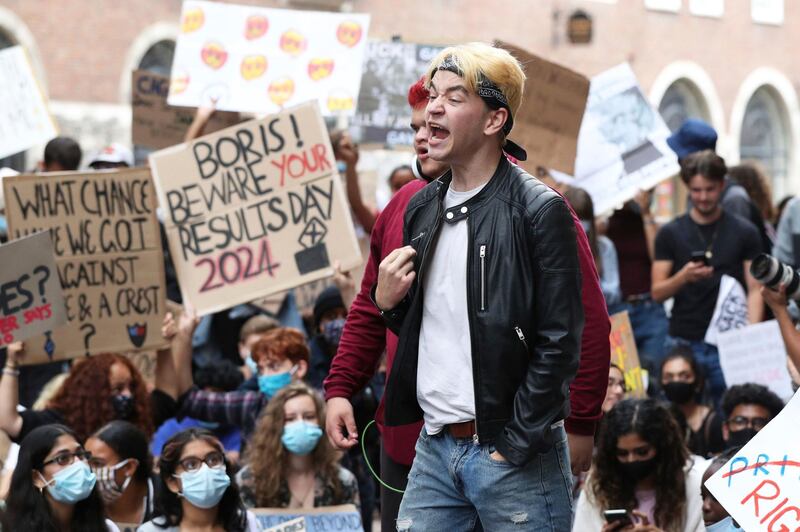 People take part in a protest outside the Department for Education, London, Sunday Aug. 16, 2020, in response to the A-level results. The British government has been urged to â€œget a gripâ€ over how grades are being awarded to school students, who were unable to take exams earlier this summer because of the coronavirus pandemic. The latest confusion emerged late Saturday when Englandâ€™s exam regulator launched a review on its own just-published guidance on how students can appeal grades awarded under a complicated system. (Jonathan Brady/PA via AP)