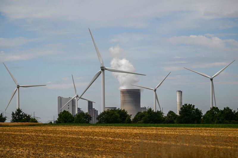 Wind turbines in front of a coal-fired power plant operated by German energy supplier RWE in Niederaussem. AFP