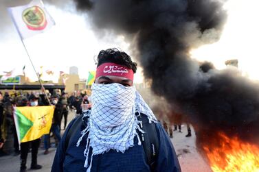 epa08098070 Members of Iran backed armed group Kataib Hezbollah (Hezbollah Brigades) set fire outside the U.S embassy inside the high security Green Zone area, in central Baghdad, Iraq, 01 January 2020. Supporters of Iranian-backed militias have withdrawn from the US Embassy in Baghdad following two days of sit-ins after a deadly US airstrike that killed 25 fighters of the Iran-backed militia on 29 December. EPA/MURTAJA LATEEF