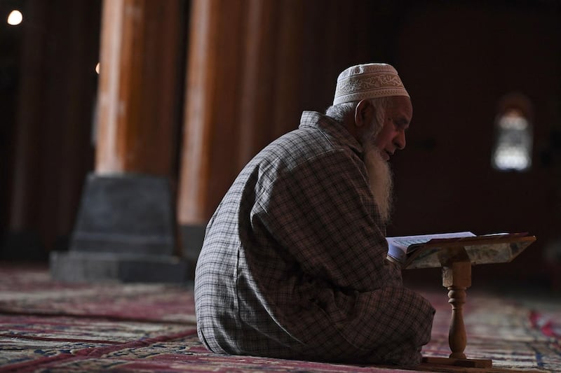 A man in the Jamia Masjid in Srinagar, India, reads the Quran during Ramadan . AFP