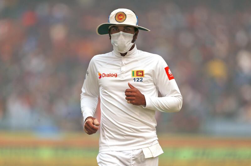 Sri Lanka's captain Dinesh Chandimal fields wearing an anti-pollution mask during the second day of their third test cricket match against India in New Delhi. Altaf Qadri / AP Photo