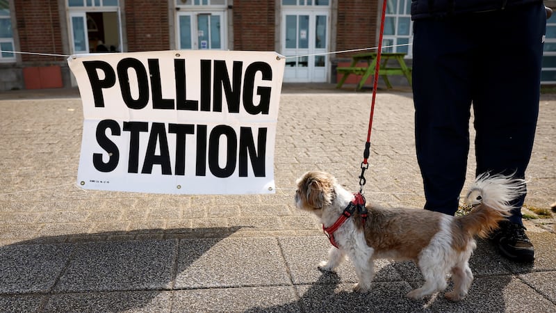 A dog stands outside a polling station in Blackpool. Reuters
