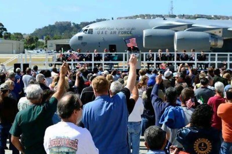 Boeing employees wave UAE and US flags during the handing-off ceremony for the first of six C-17 Globemaster III airlifters. Kevork Djansezian / Getty Images / AFP