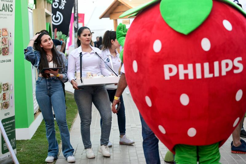 Servers hand out testers at Taste of Dubai 
