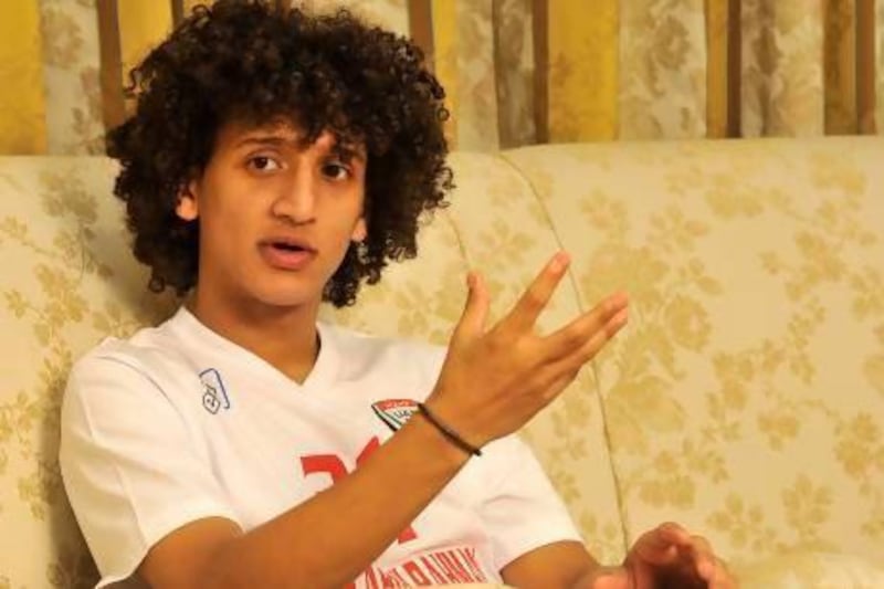 The slight frame of Emirati footballer Omar Abdulrahman on a sofa contrasts with his burgeoning football career.