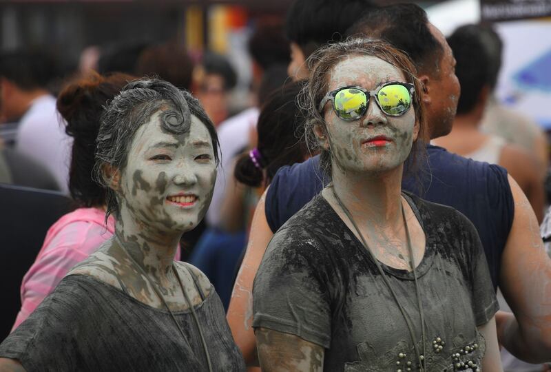 Tourists are covered in mud during the festival, which aims to encourage the use of mud for cosmetic skin-care and to promote tourism in the region. Jung Yeon-Je