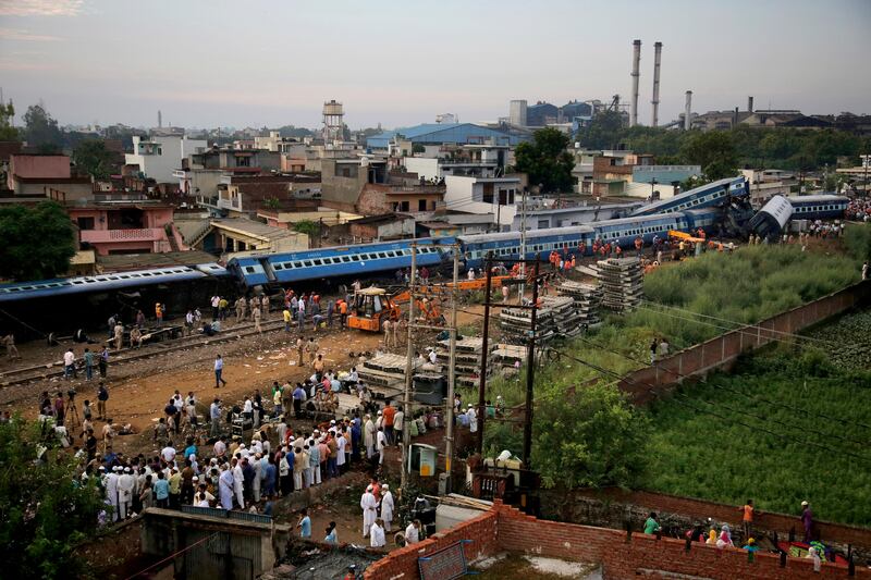 Rescuers using cutting torches and cranes have worked through the night to pull apart 14 coaches of a crowded train that went off the tracks in northern India. Altaf Qadri / The Associated Press