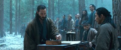 A handout movie still showing L to R, foreground) Kai (KEANU REEVES) signs an oath as Oishi (HIROYUKI SANADA) silently observes in the action-adventure "47 Ronin". After a treacherous warlord kills their master and banishes their kind, 47 leaderless samurai vow to seek vengeance and restore honor to their people. Driven from their homes and dispersed across the land, this band of Ronin must seek the help of Kai (Reeves)--a half-breed they once rejected--as they fight their way across a savage world of mythic beasts, shape-shifting witchcraft and wondrous terrors. (Courtesy: Universal Pictures) *** Local Caption ***  AL30DE-MOVIES-RONIN.JPG