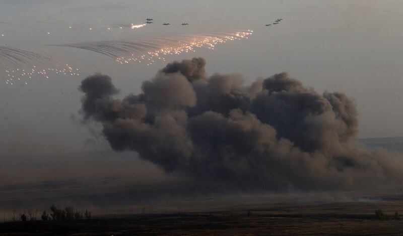 ORENBURG, RUSSIA- SEPTEMBER 19: Planes drop bombs during Russias large-scale Center-2015 military exercises at Donguzsky Range September 19, 2015 in Orenburg, Russia, The exercises, aim to contain the outbreak of an armed conflict in Central Asia. Putin said this week that it's impossible to defeat Islamic State group without support of the government of Syria and that Moscow has provided military assistance to President Bashar al-Assad's regime and will continue to do so. (Photo by Sasha Mordovets/Getty Images)