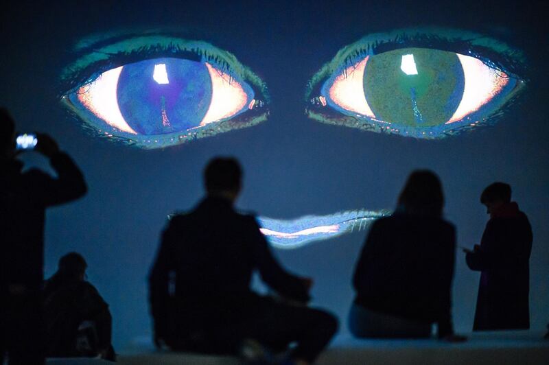 Visitors stand in front of a video installation of the artwork 'The Demon's Brain' by Polish artist Agnieszka Polska (not in the picture) at the 'Hamburger Bahnhof' exhibition hall in Berlin.  EPA