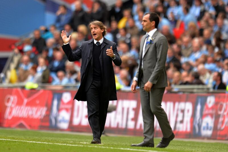 LONDON, ENGLAND - MAY 11:  Manager Roberto Mancini (L) of Manchester City directs his players as Manager Roberto Martinez of Wigan Athletic looks on during the FA Cup with Budweiser Final between Manchester City and Wigan Athletic at Wembley Stadium on May 11, 2013 in London, England.  (Photo by Shaun Botterill/Getty Images)