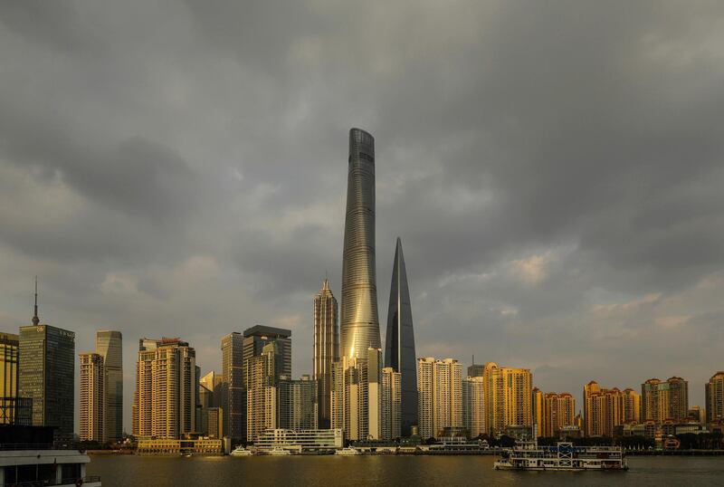 The Shanghai Tower, center, stands among other buildings in Shanghai, China, on Friday, Dec. 1, 2017. After more than two years of red tape that kept tenants from moving in, China's tallest skyscraper, the Shanghai Tower, has been quietly opening and filling office space. Photographer: Qilai Shen/Bloomberg