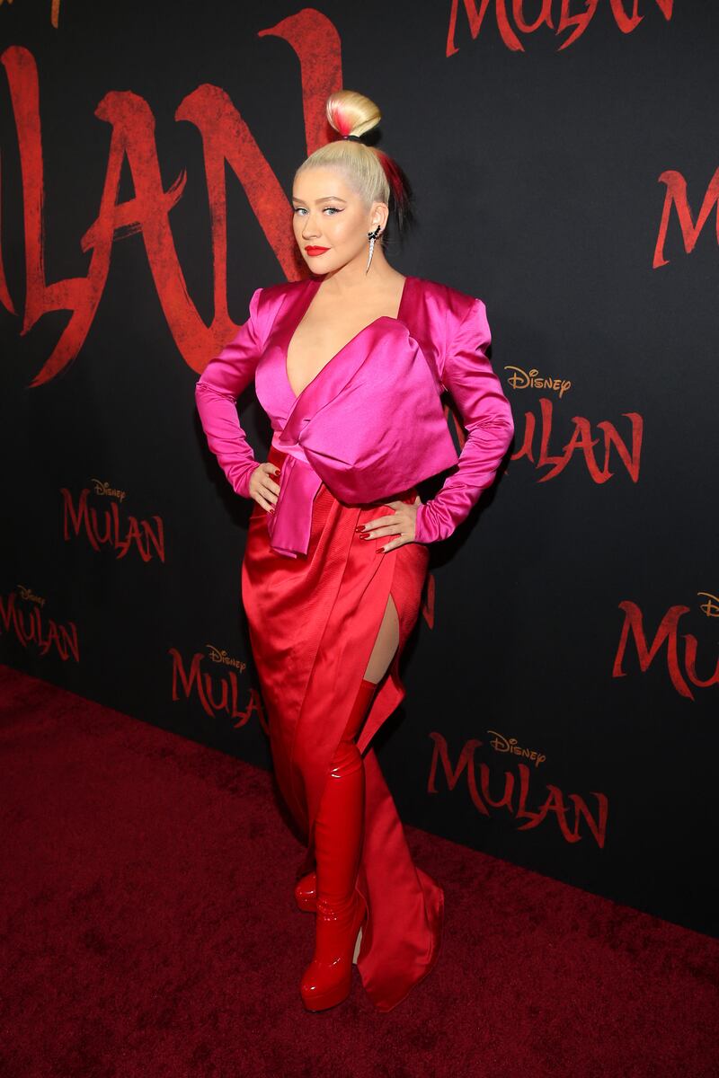 Christina Aguilera, wearing a red and pink gown Galia Lahav, attends the premiere of 'Mulan' in Hollywood on March 9, 2020. AFP