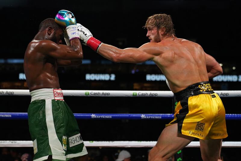 Floyd Mayweather blocks a punch from Logan Paul during an exhibition bout at Hard Rock Stadium. Reuters