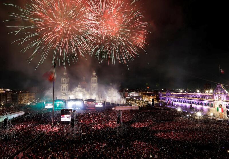 People enjoy fireworks after the "Cry of Independence" as Mexico marks the 209th anniversary of its independence from Spain at the National Palace in Mexico City, Mexico.  Reuters