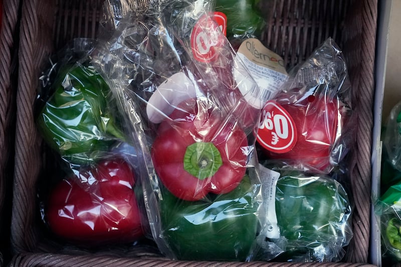 Peppers wrapped in plastic in a grocery stall in Paris before a French government ban on such packaging went into effect on January 1, 2022. AP Photo