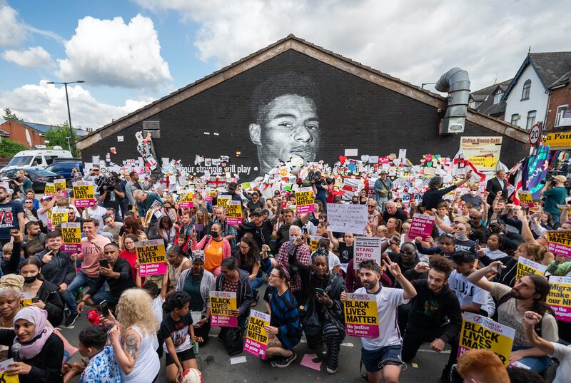 Fans show their support for Marcus Rashford on July 13 after a mural of the England striker was vandalised in Withington, Manchester, after he missed a penalty in the Euro 2020 final defeat to Italy. PA