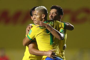 Brazil's Roberto Firmino, right, celebrates with teammates after scoring his side's goal against Venezuela. AP