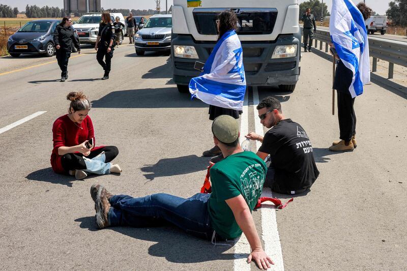 Israeli protesters block the road to Jordanian lorries carrying humanitarian aid in southern Israel on April 16. That such disruptive actions are allowed to repeatedly take place shows the impunity enjoyed by some right-wing groups in Israel. AFP