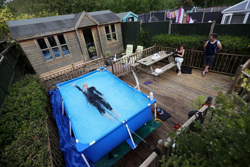 Triathlete Lloyd Bebbington trains in a pool in his garden at home  in Newcastle-under-Lyme, England, on April 26, following the outbreak of the coronavirus. Reuters