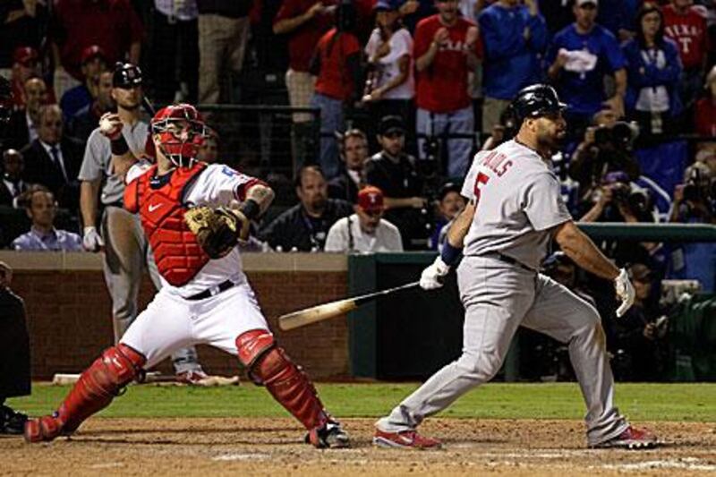 Mike Napoli, left, throws out Allen Craig on second base, in a double-play which saw the dangerous St Louis batsman Albert Pujols striking out in the ninth inning. Texas Rangers lead the World Series 3-2.