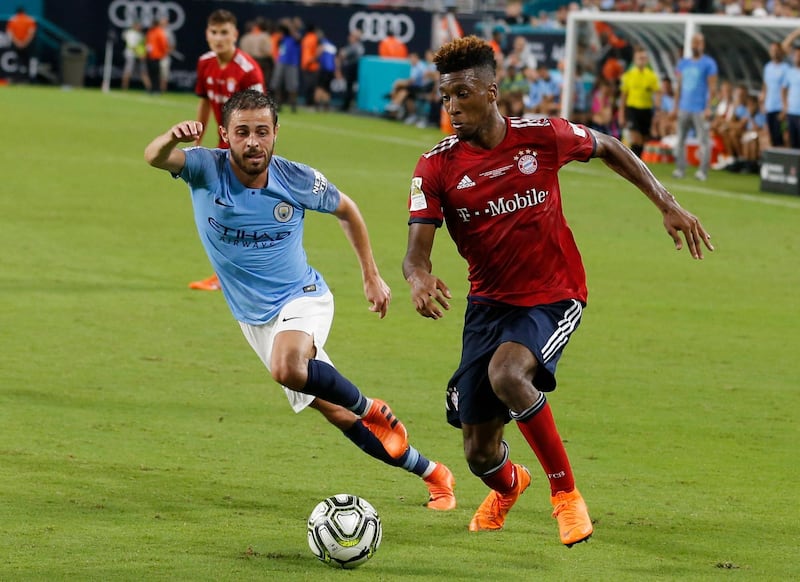 Bayern Munich's Kingsley Coman holds off Manchester City Bernardo Silva. EPA
