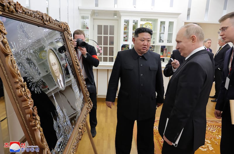 North Korea's leader Kim Jong-un presents a gift to Russia's President Vladimir Putin in Pyongyang. AFP 