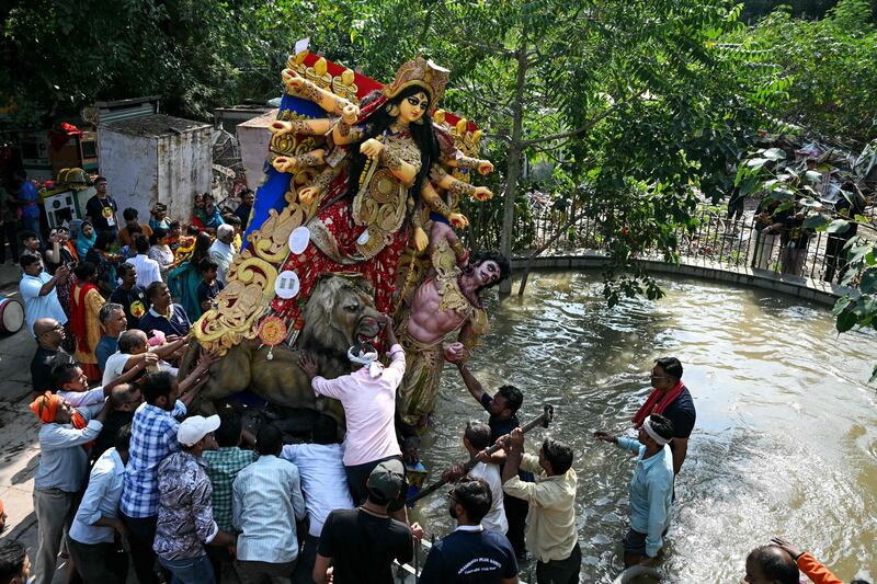 Devotees immerse an idol of Hindu deity Durga in a tank on the final day of the 'Durga Puja' festival in New Delhi. AFP